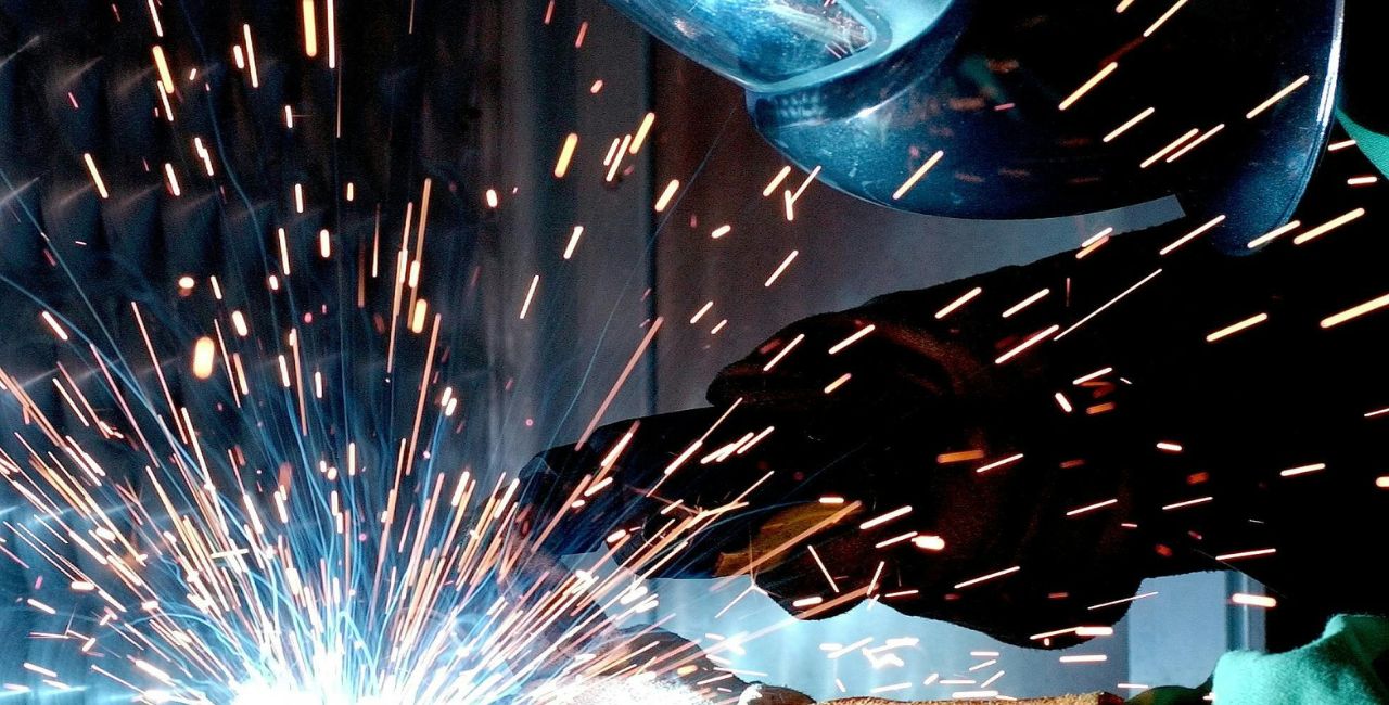 A person welding with sparks flying.