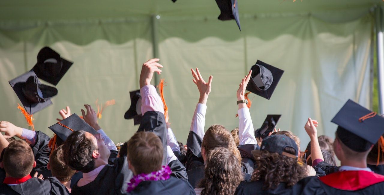 Students throwing graduation caps.