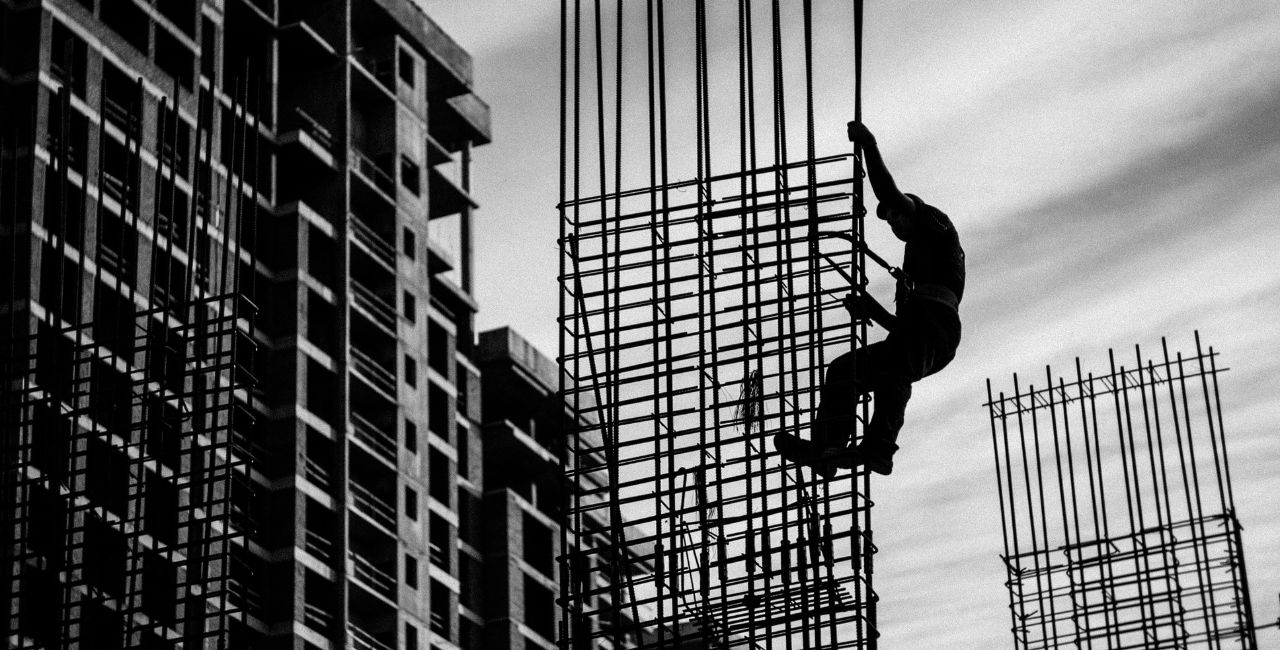 A man building a steel frame for a building.