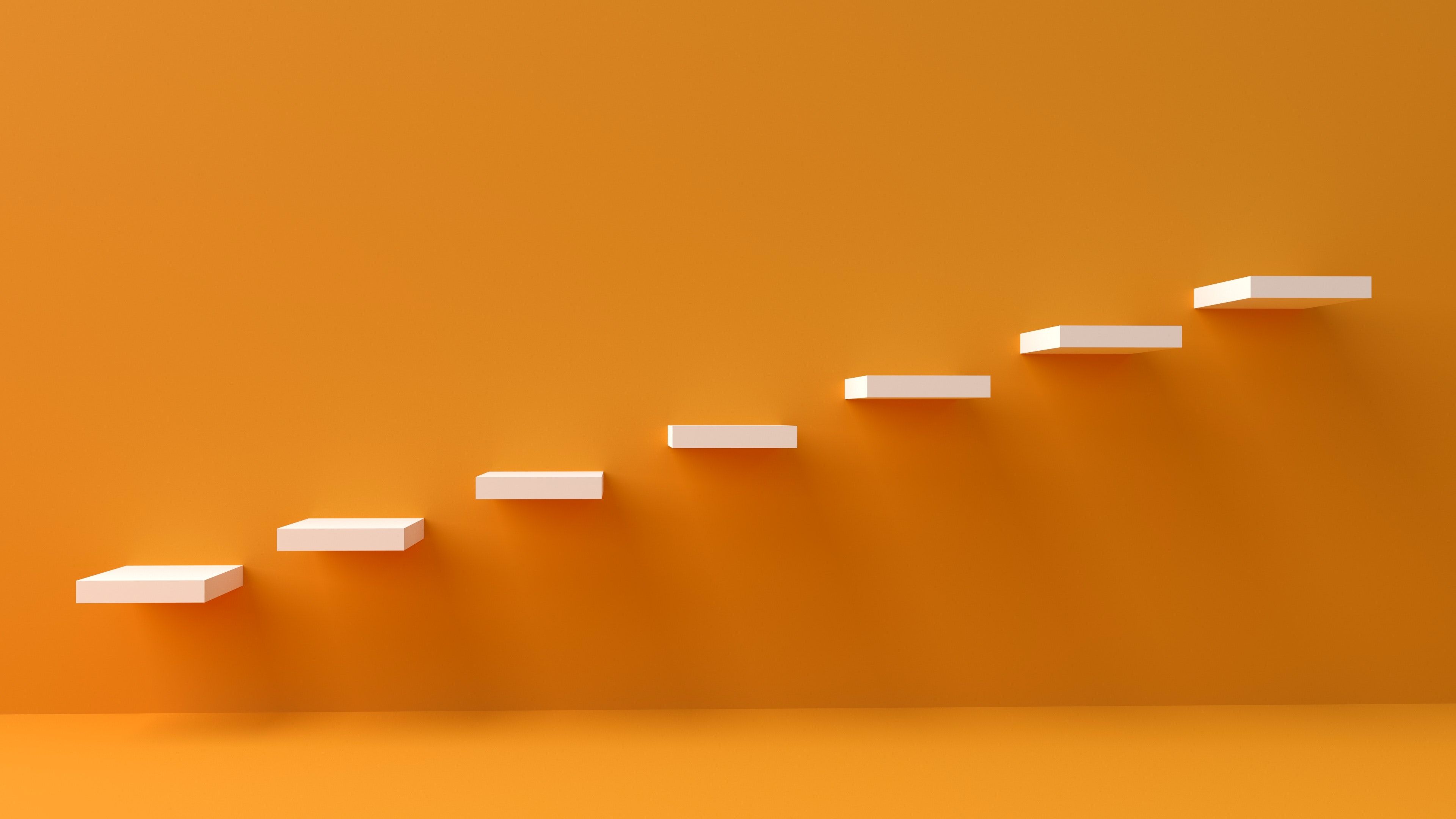Photo of stairs designed in a modern fashion over an orange background