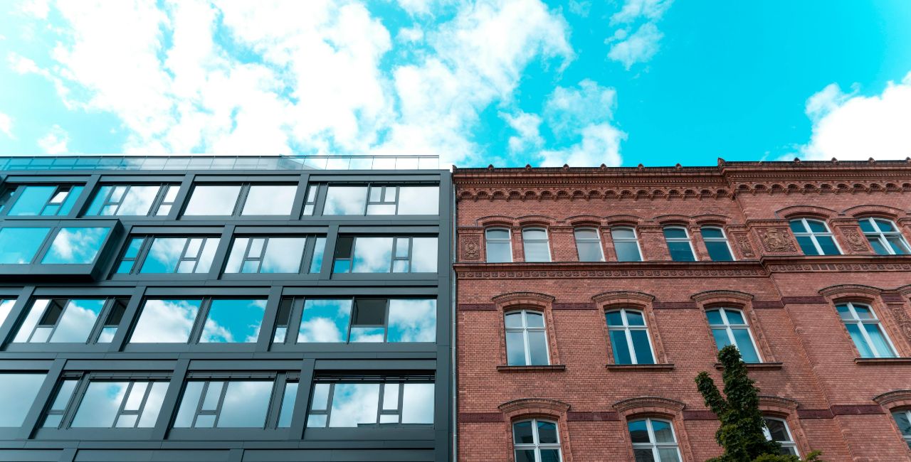 An old and a new building standing adjacent to each other.