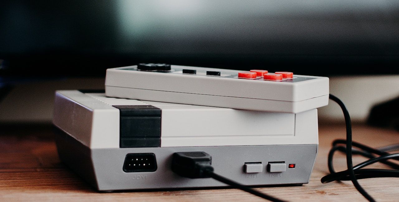 A photo of a retro gaming console and controller.
