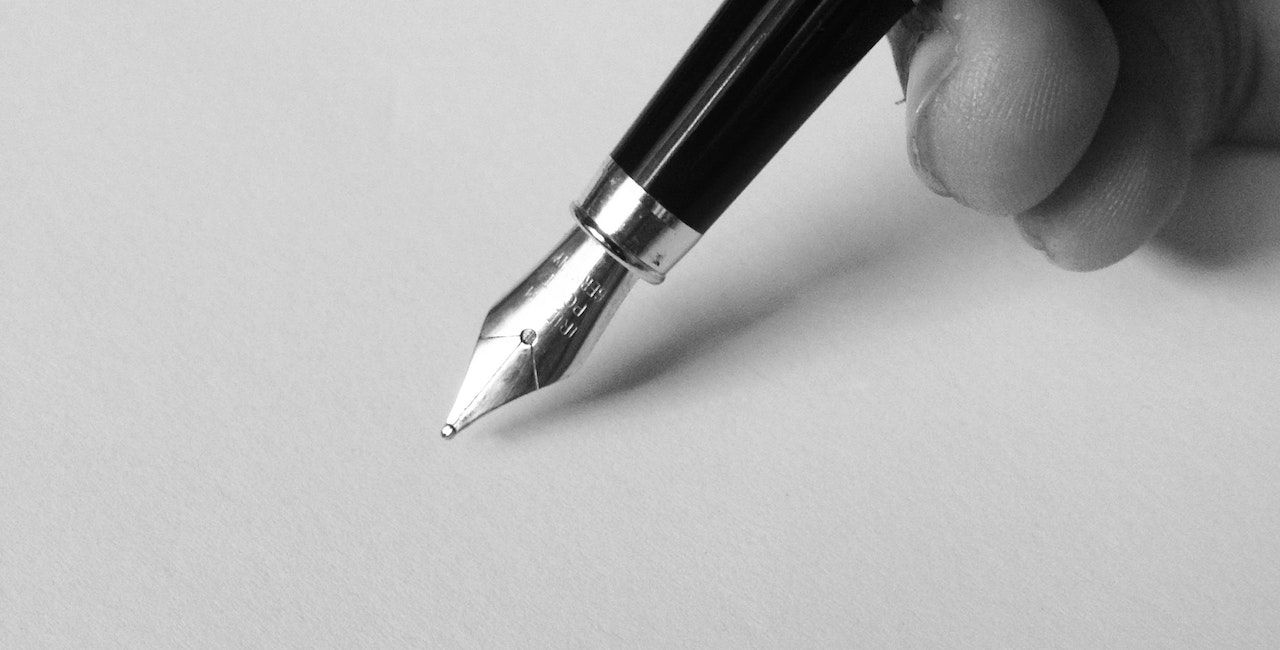 A photo of a fountain pen on a paper.